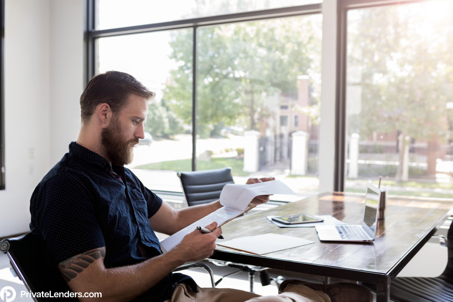 Real estate investor reviewing rental property financing documents