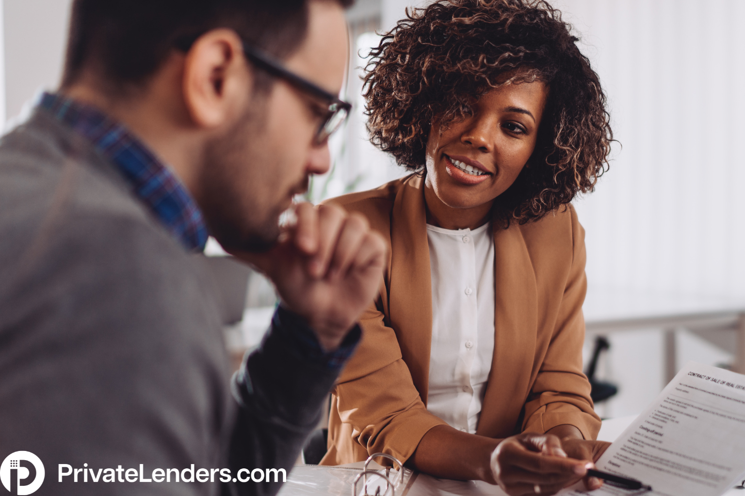 A man and woman having a meeting about real estate investments and private lending options